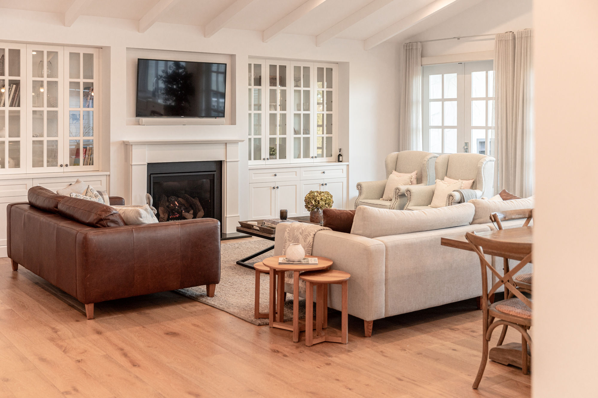 The living room at Birchgrove, light-filled with an open fire.