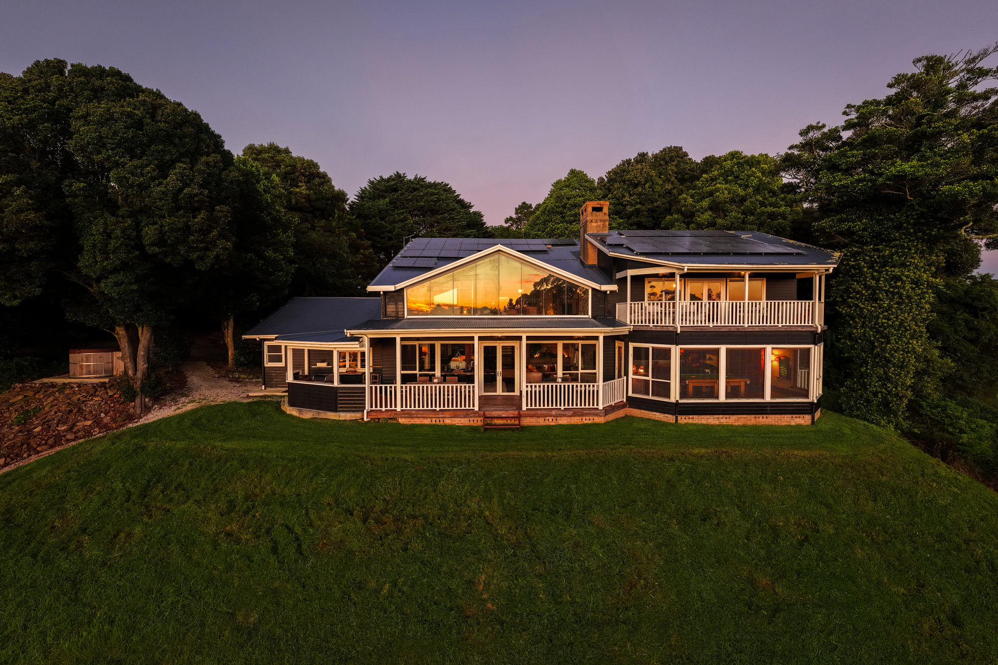 Wildefell Estate at twilight, the lit house on its lawn.